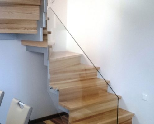 Glass handrails on wooden stairs