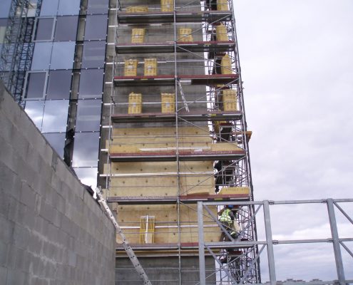 Wall insulation installation on office building